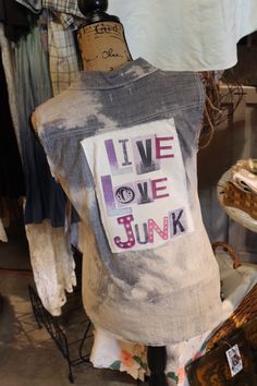 a shirt that says live love junk is on display in a clothing store with other items