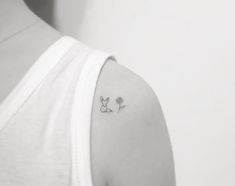 a woman with a small tattoo on her shoulder