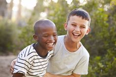 two young boys are smiling for the camera