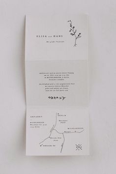 the back and side of a folded wedding card with an arrow on it, in black ink