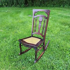 an old rocking chair sitting in the grass