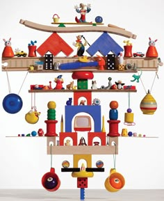 a toy house with lots of toys hanging from it's sides and on the shelves