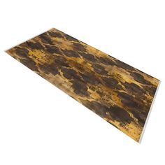 a piece of wood that looks like it has been painted gold and brown with black spots