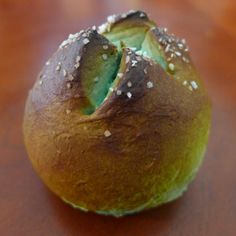 a bun with sesame seeds on it sitting on a table