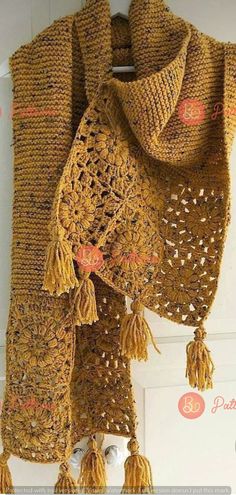 a crocheted scarf with tassels hanging from it