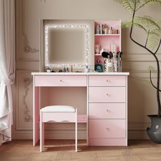 a pink desk with a mirror and lights on it