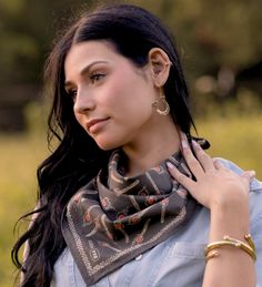 a woman with long black hair wearing a scarf