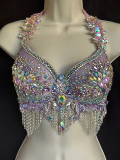 the bra is adorned with multicolored beads and sequins, which are attached to a mannequin