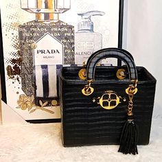 Nwot Very Classy "Iman" Croc Embossed Black & Gold Large Vegan Leather Handbag, Detachable Tassel, 4 Gold Feet, Inside Zip Pocket, Clean Signature Monogram Tan Inside Lining. Beautiful Shiny Gold Hardware! No Call Outs! *Approx: 11" H X 9" W X 6" D Handles 5" No Pets, No Smoke, No Flaws *Shoes Sold Separately!! 6 D, Leather Handbag, Emboss, Gold Hardware, Leather Handbags, Vegan Leather, Zip Pockets, Handles, Bag Lady