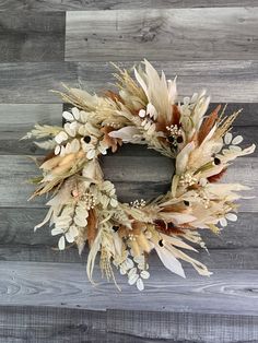 a dried wreath on a wooden wall