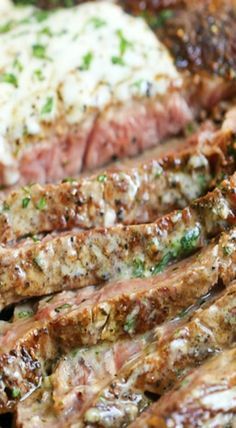 steaks and mashed potatoes on a plate with green garnish in the middle