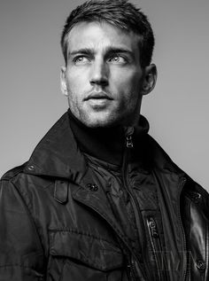 black and white photograph of a man in a leather jacket looking up at the camera