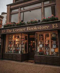 the corner bookstore 13 is located in an old brick building with flower boxes on it's windows