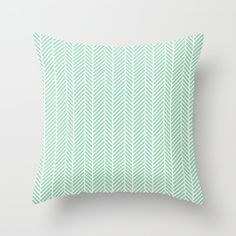 a green and white pillow with an arrow pattern