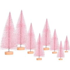 small pink trees are lined up in the shape of christmas trees, with wooden bases