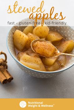 a bowl filled with sliced apples next to cinnamon sticks and an apple cider on the side