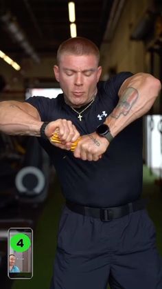 a man with tattoos on his arms and arm muscles is holding something in one hand