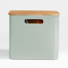 a green storage box with a wooden lid