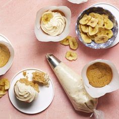 bananas and peanut butter in bowls next to an electric mixer on a pink tablecloth