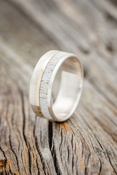 a wedding ring with white wood in the middle