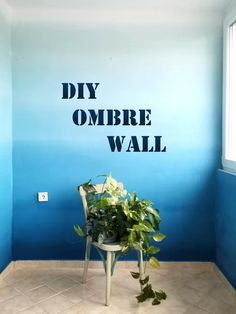 a chair sitting in front of a blue wall with the words diy ombre wall painted on it