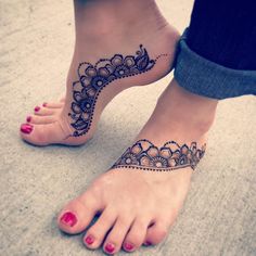 a woman's foot with a henna tattoo on her left leg and the bottom part of her feet