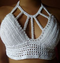 a woman wearing a white crochet bra top