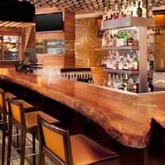 a wooden bar with lots of bottles on it