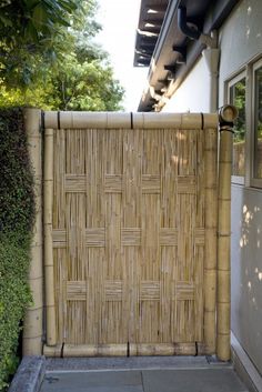 a bamboo fence is in front of a house