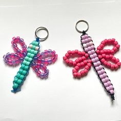 two key chains made out of bead and plastic beads, one with a dragonfly on it