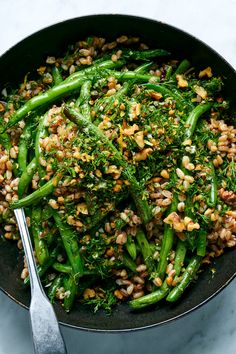 a skillet filled with broccoli and grains