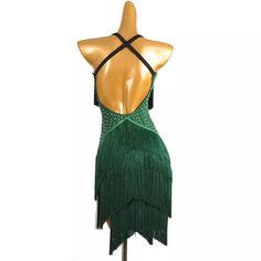 a mannequin wearing a green dress with fringes on the bottom and back