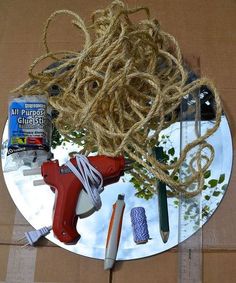 a plate with some scissors and other items on it next to a roped cord