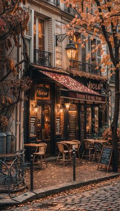 the outside of a restaurant with tables and chairs in front of it on a cobblestone street