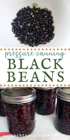 three jars filled with black beans sitting on top of a table