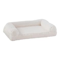 a white dog bed that is shaped like a couch