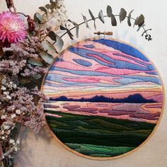 an embroidery project is shown with flowers and plants