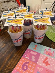 there are four cups of cereal on the table with signs in front of them that say, you're super sonic