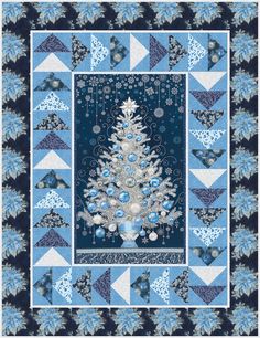 a quilted christmas tree with blue and white snowflakes on it, in the middle