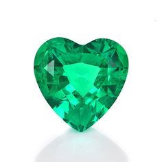 an emerald heart shaped stone on a white background