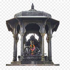 a statue in the middle of a pavilion with a man sitting on top of it