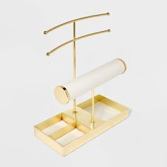 a gold and white desk set with a roll of paper on it's stand