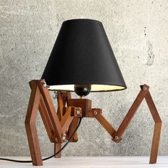 a lamp on a table next to a potted plant