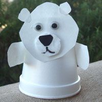 a white bear head on top of a cup