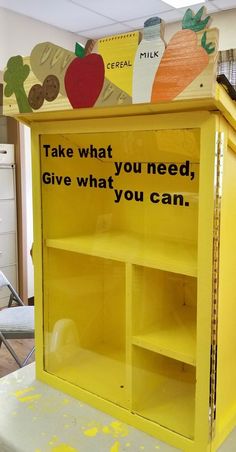 a yellow cabinet with an advertisement on it