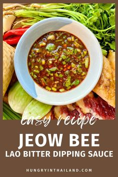 a bowl of soup on top of a pile of vegetables with the words easy recipe jeow bee lao bitter dipping sauce