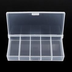 an empty plastic box with compartments on black background