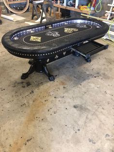 a table that is sitting on top of some kind of stand in a room with other items