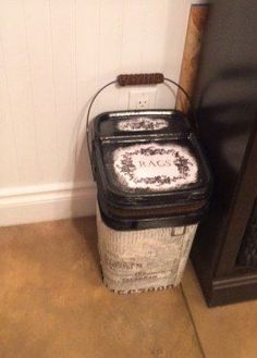 a trash can sitting next to a book shelf