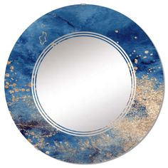 a round mirror with blue and gold paint on it